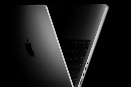 The new 14-inch MacBook Pro shown propped open and angled to the side.