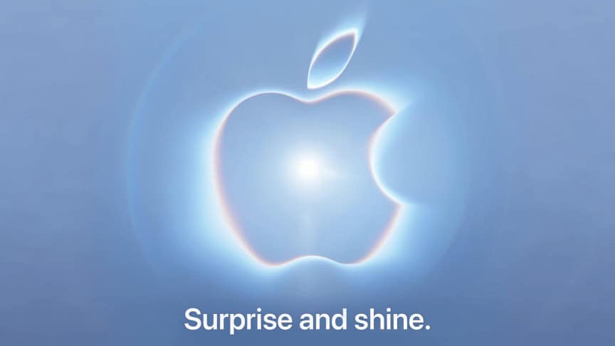 Apple graphic showing its logo with a bright light at the center on a blue-gray background. text: Surprise and shine